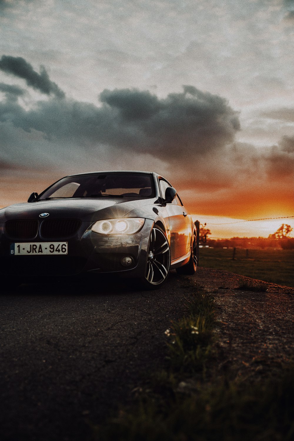 black porsche 911 on brown field under gray clouds