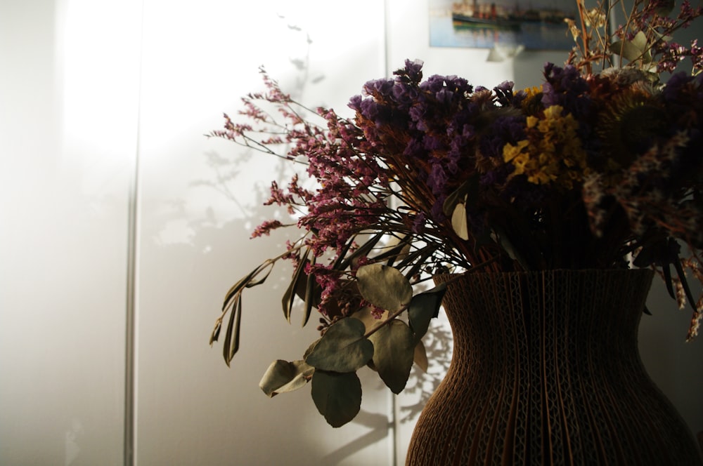 purple and white flowers in vase