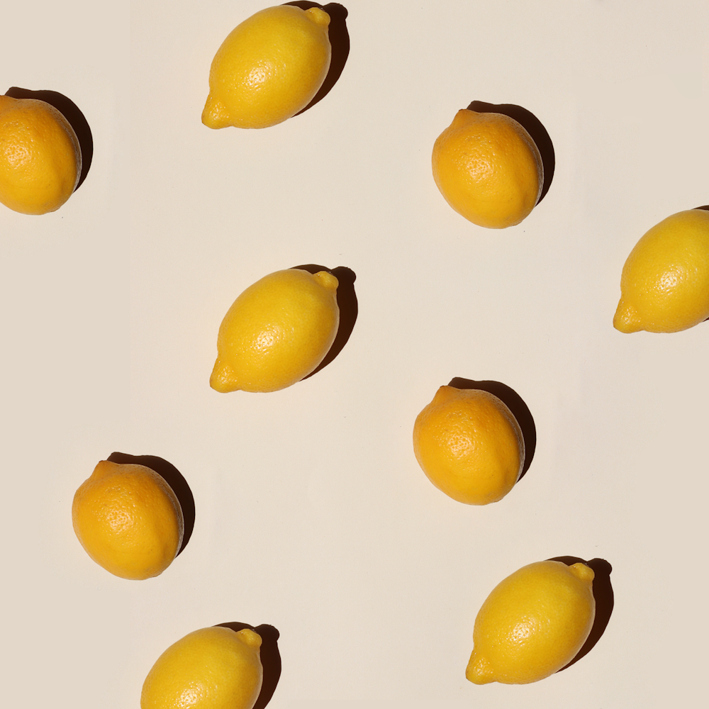 yellow lemon fruits on white surface