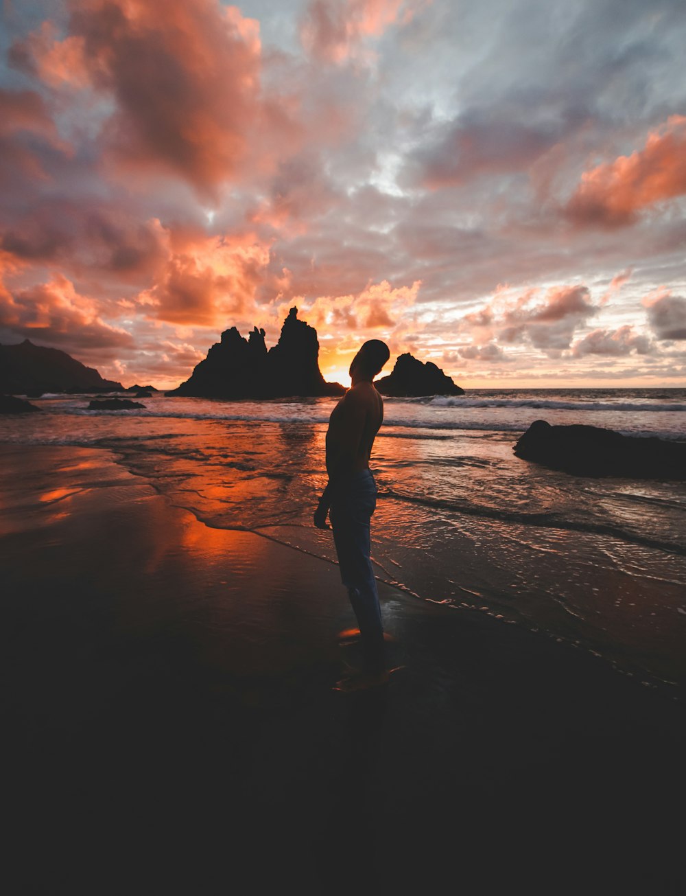 silhouette of man and woman kissing on beach during sunset