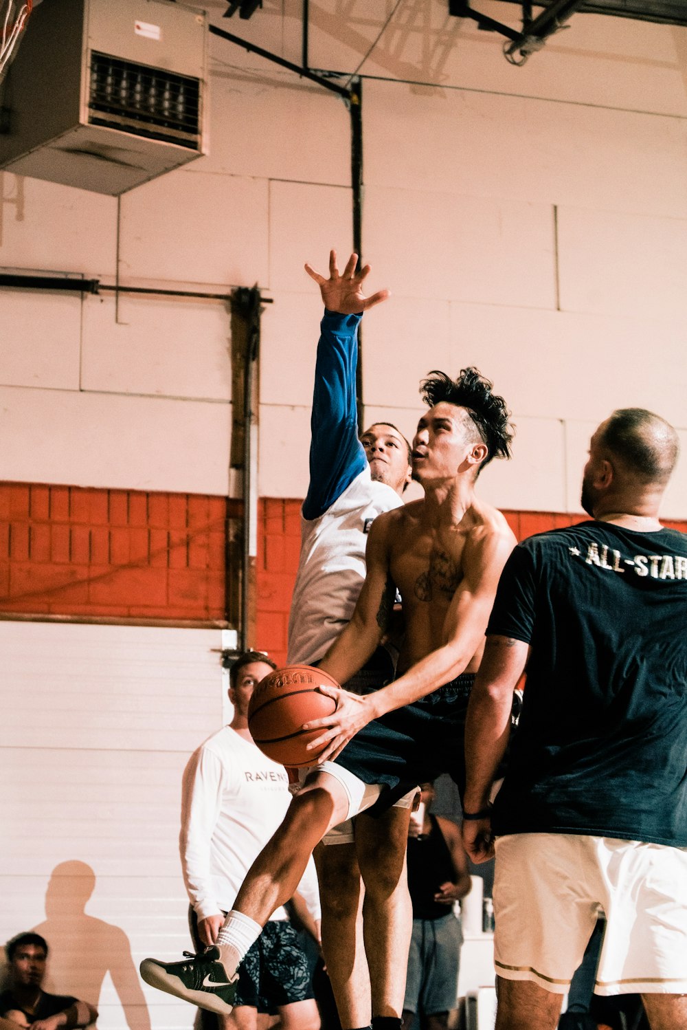 2 men in black tank top playing basketball