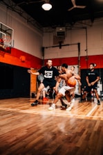 Group of diverse members enjoying a friendly match on a sleek indoor court.