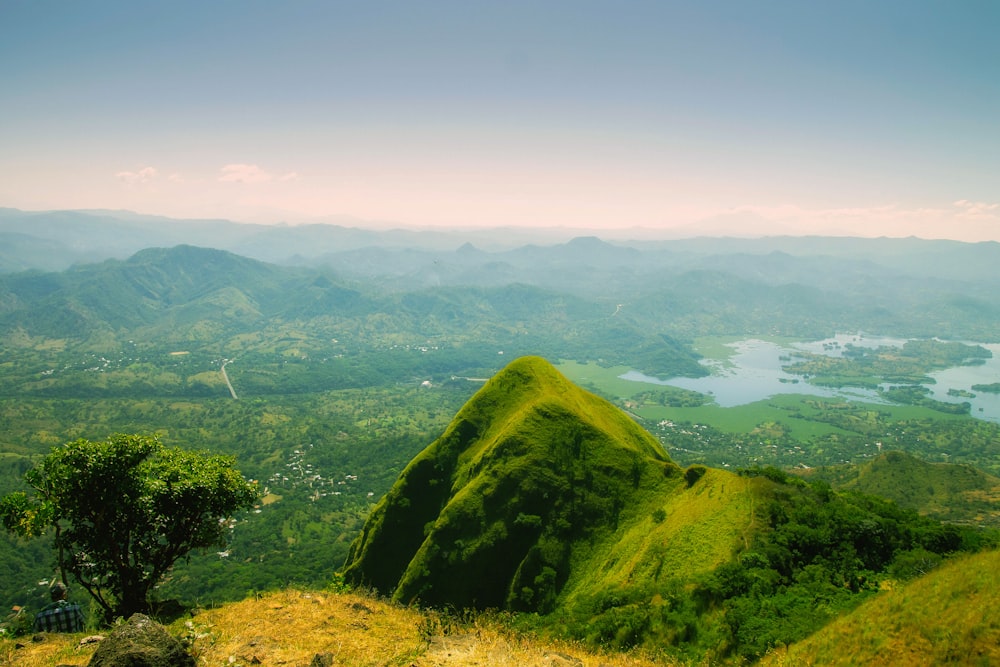 green mountain near body of water during daytime