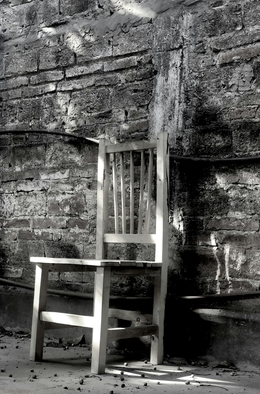 brown wooden chair on gray concrete wall