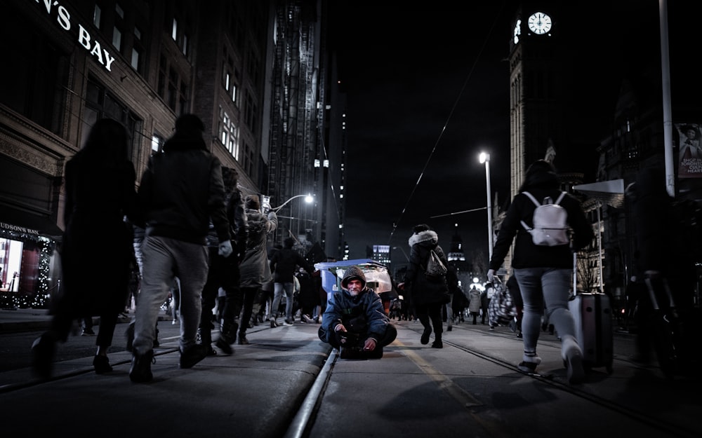 people walking on pedestrian lane during night time