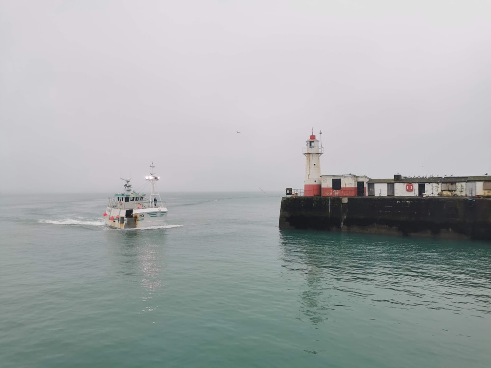 red and white ship on sea during daytime