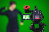 man in black shirt standing near black video camera