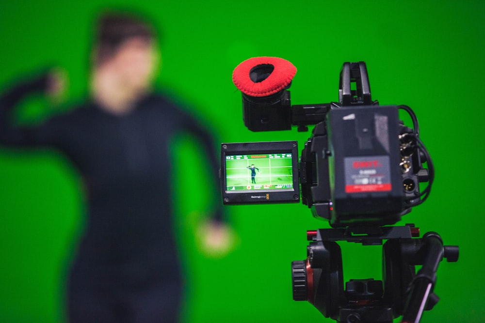 man in black shirt standing near black video camera