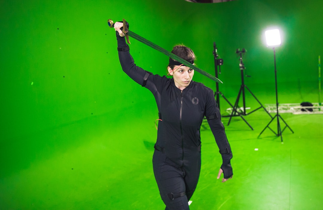 man in black long sleeve shirt and black pants holding microphone,