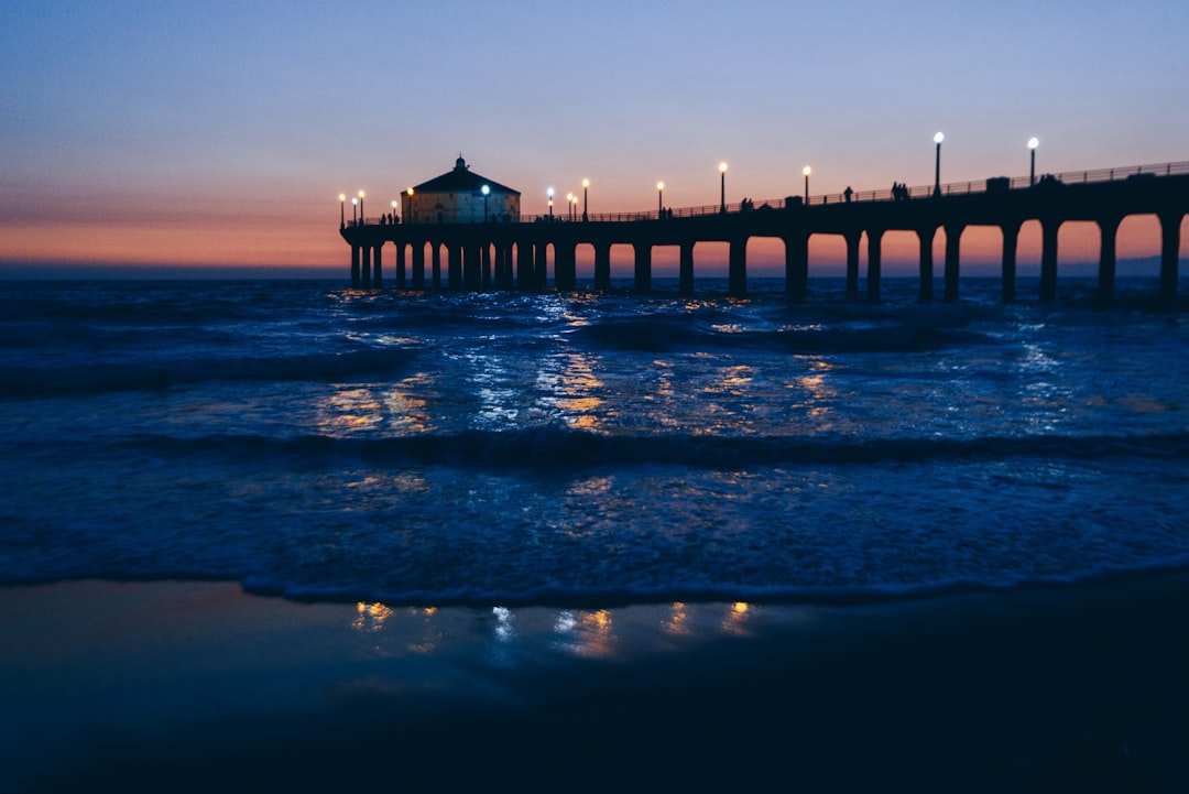 brown wooden dock on sea during sunset