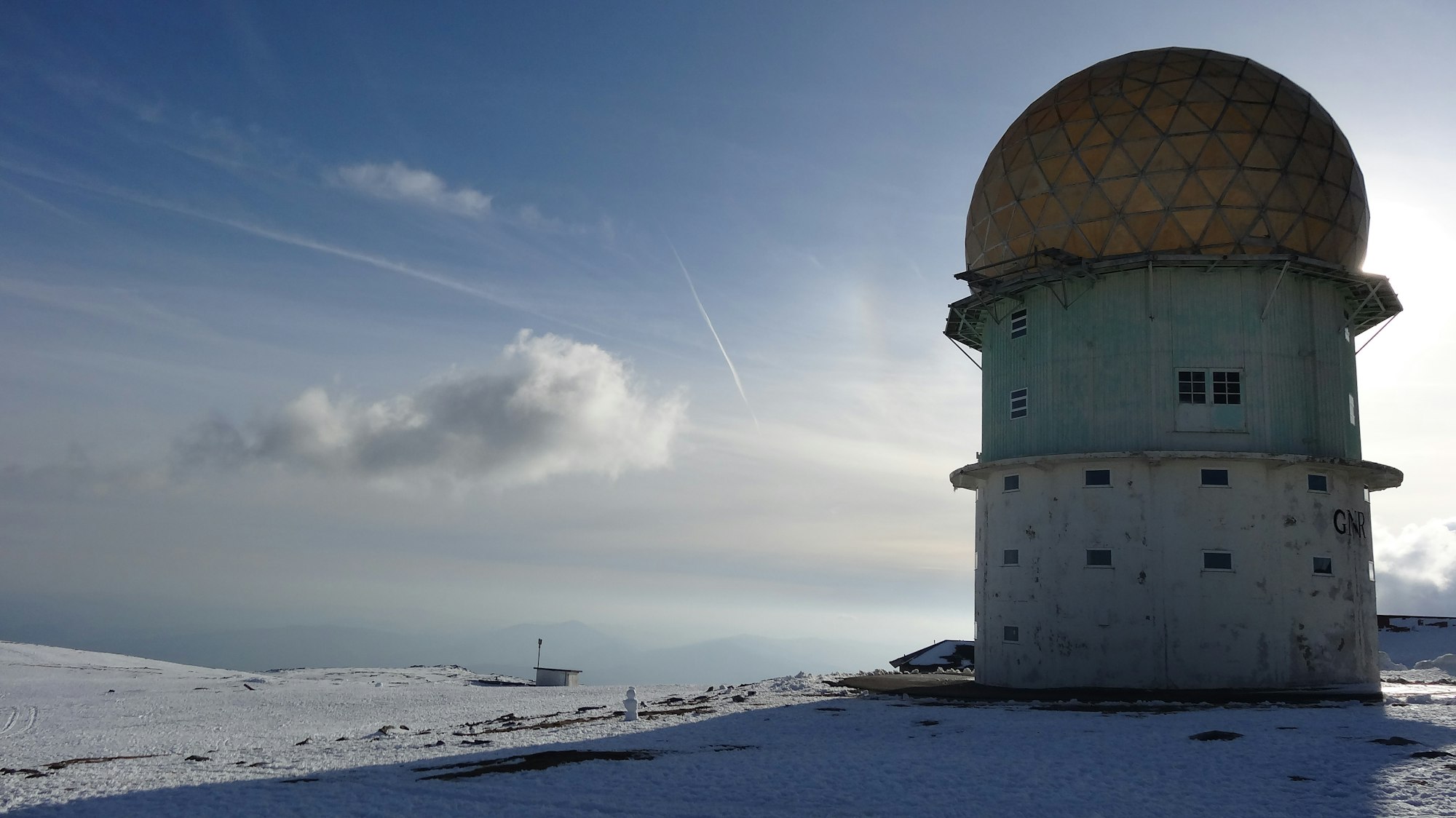 Serra da Estrela tower between the snow and sunny landscape.