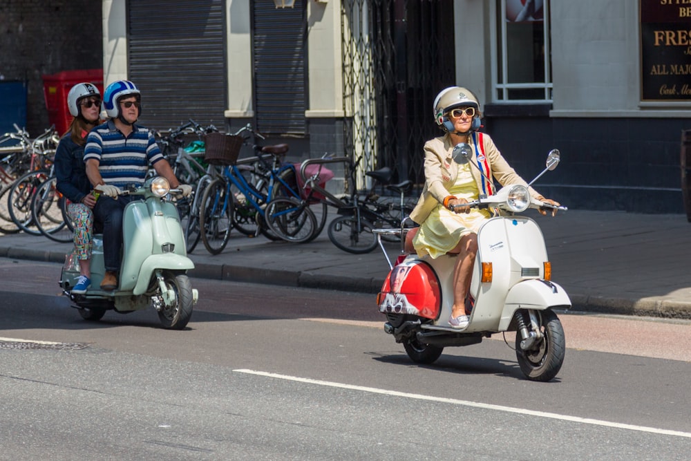 woman in yellow and white dress riding on white and red motor scooter during daytime
