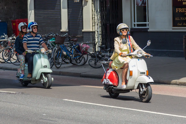 Rider on a red and white scooter