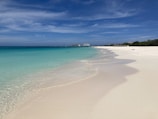 A stunning beach with clear blue waters and white sand.