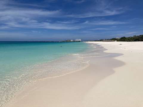 A stunning beach with clear blue waters and white sand.