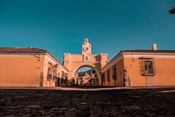 People walking on street near brown concrete building during daytime — Antigua, Guatemala