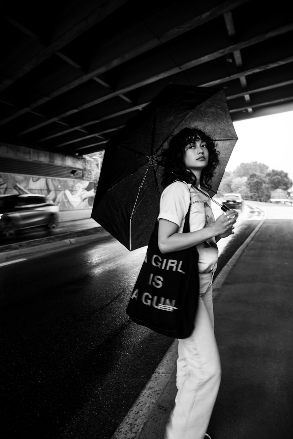 grayscale photo of woman holding umbrella