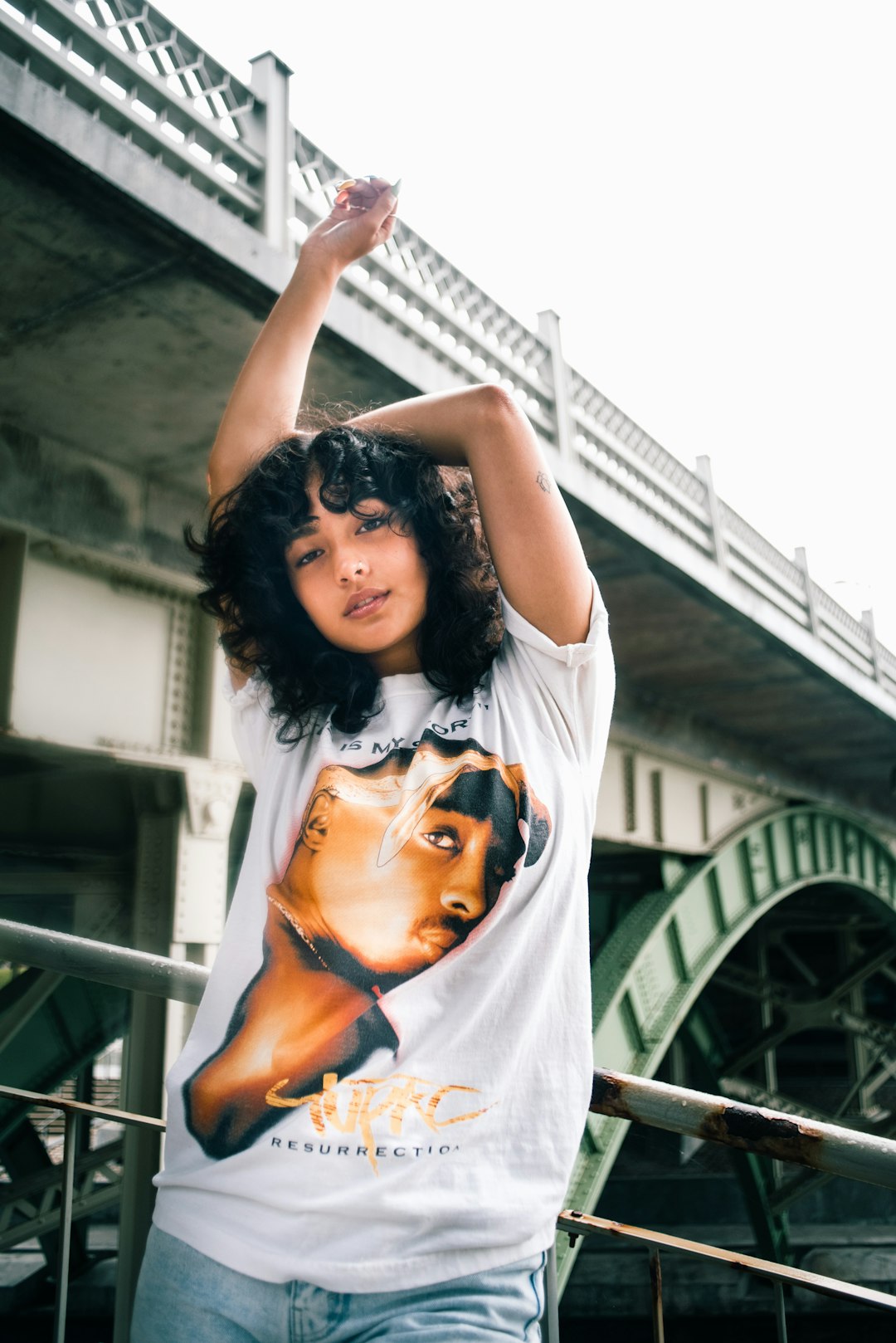 woman in white t-shirt raising her hands