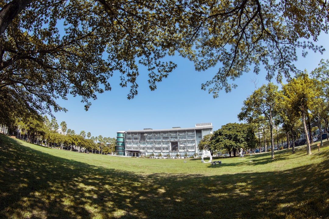 white concrete building near green grass field during daytime