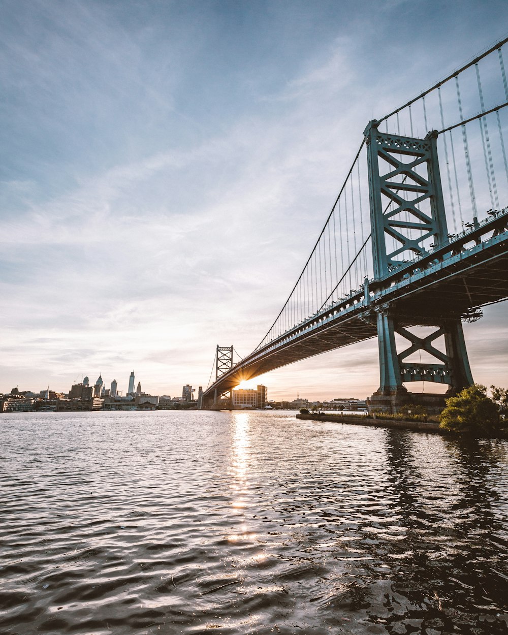 gray bridge under cloudy sky during daytime