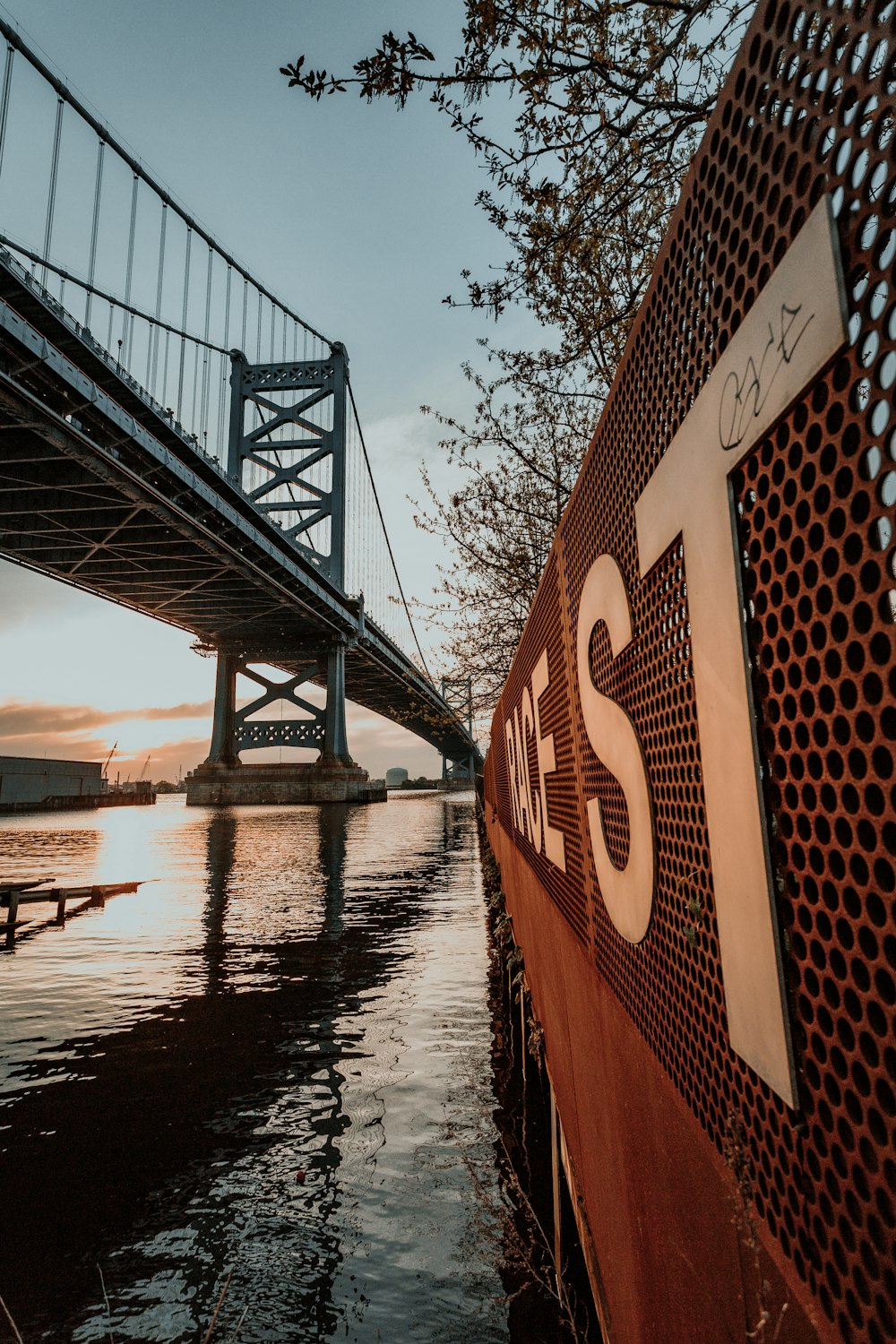 a bridge over a body of water with a bridge in the background