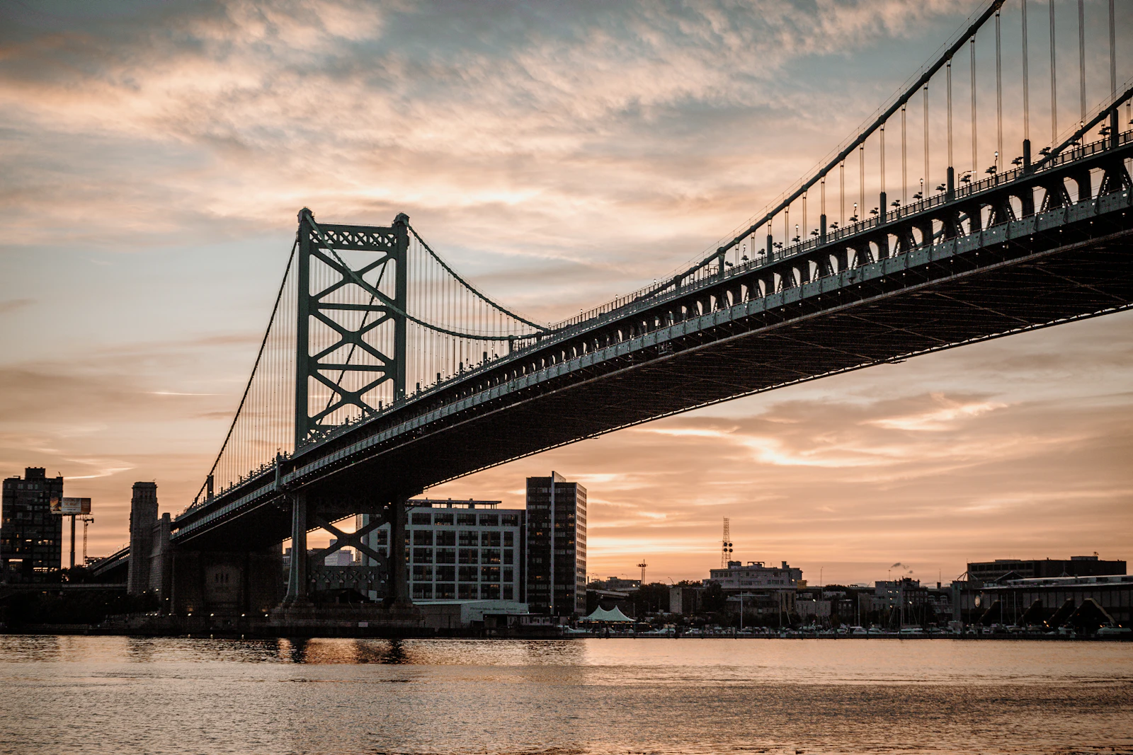 Ben Franklin Bridge over the Delaware River at dusk, connecting Philadelphia and Camden
