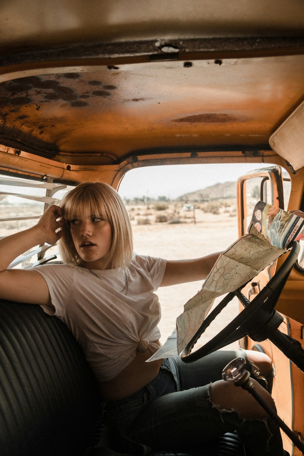 woman in white t-shirt sitting on car seat