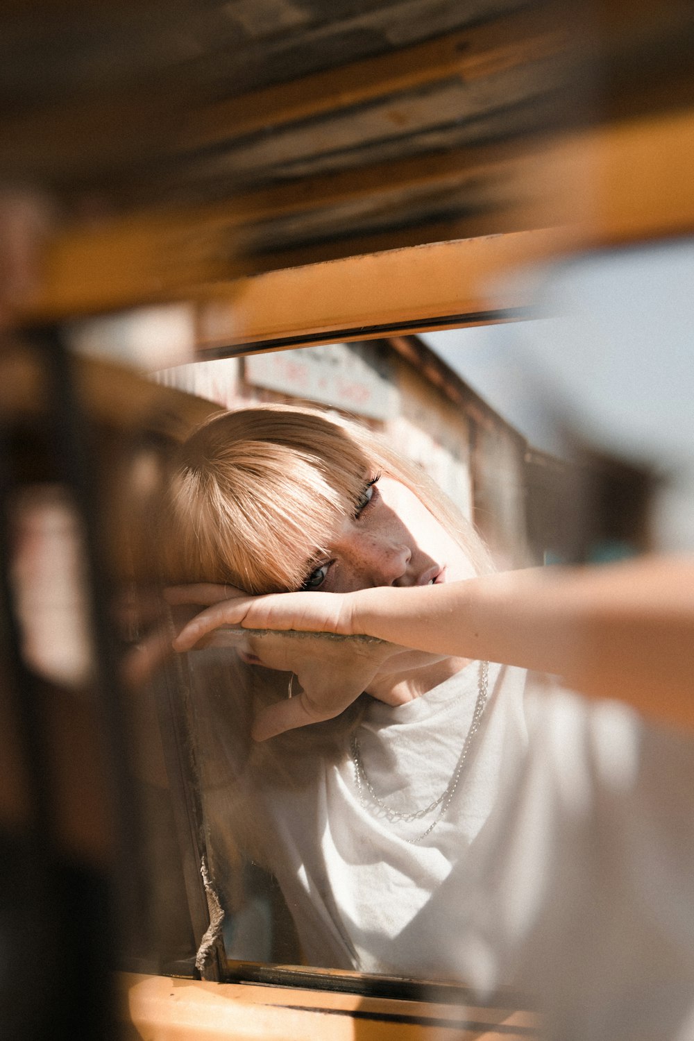 woman in white shirt holding her hair