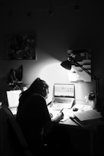 woman in black shirt sitting in front of computer