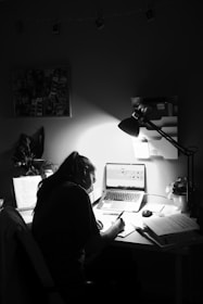 woman in black shirt sitting in front of computer