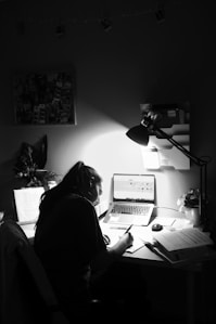 woman in black shirt sitting in front of computer