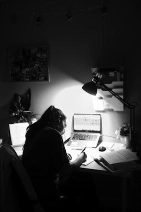 woman in black shirt sitting in front of computer