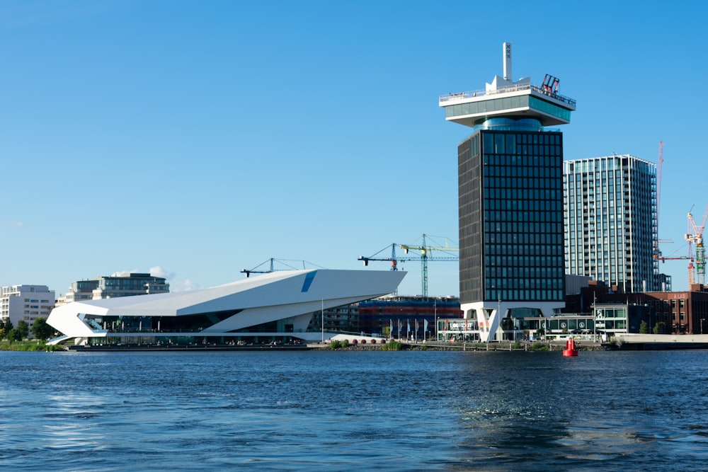 white and gray building near body of water during daytime