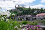 A scenic view of a historic castle surrounded by greenery.