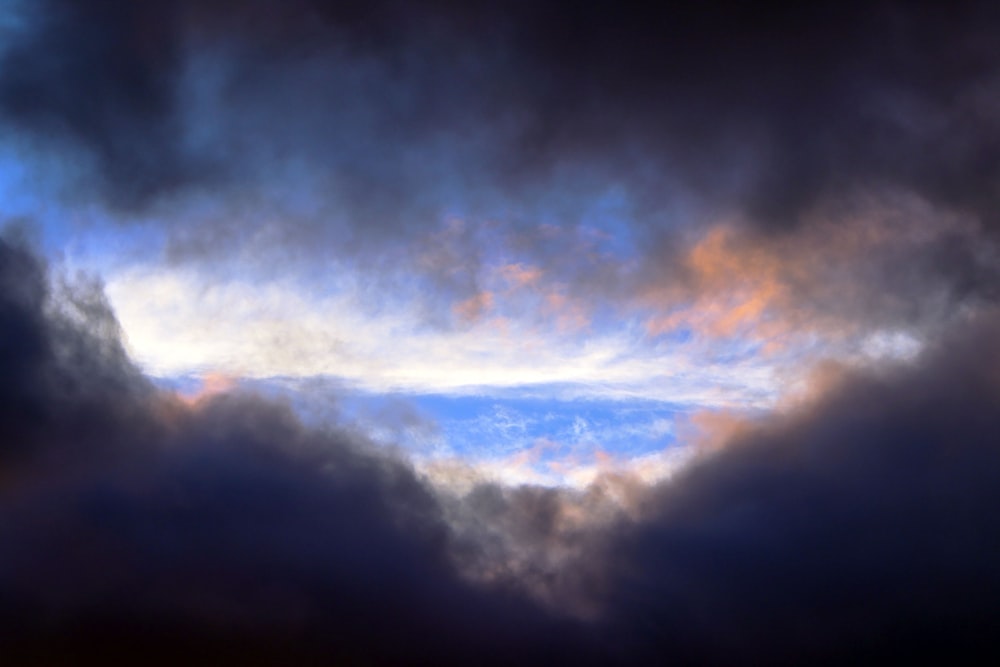 white clouds over brown mountain