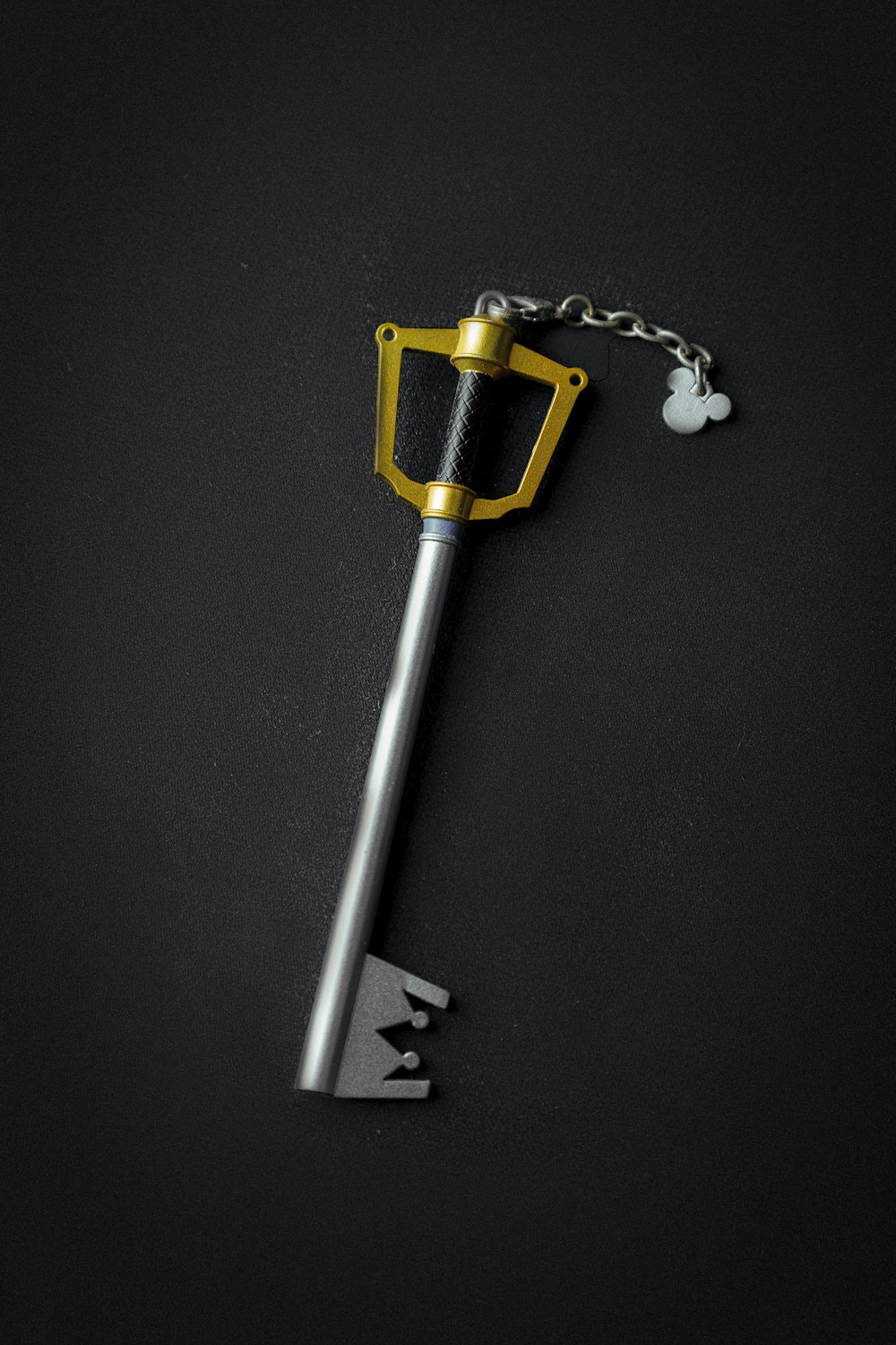 silver key chain on black surface