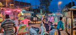 An evening market bustling with vendors and locals exchanging fresh produce and handmade goods