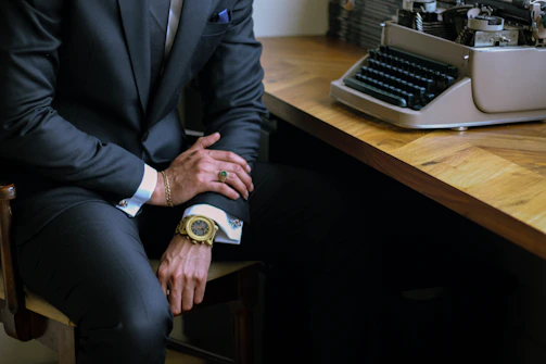 A legal expert drafting a formal legal notice on a sleek black and gold themed desk.