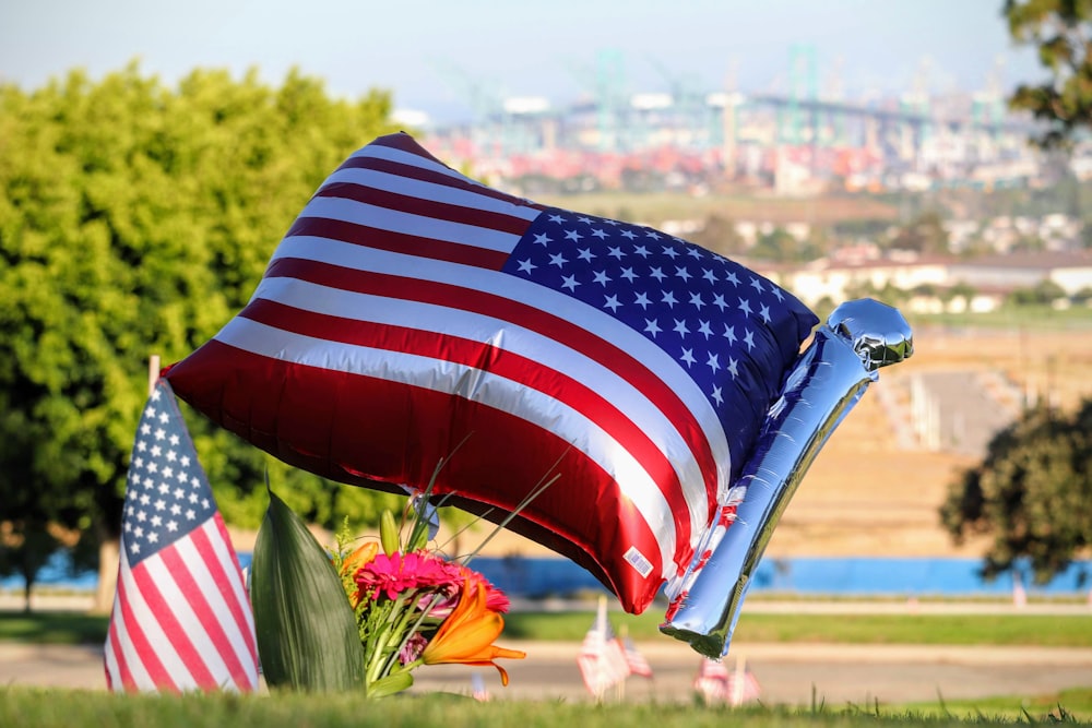 us a flag on green grass field during daytime