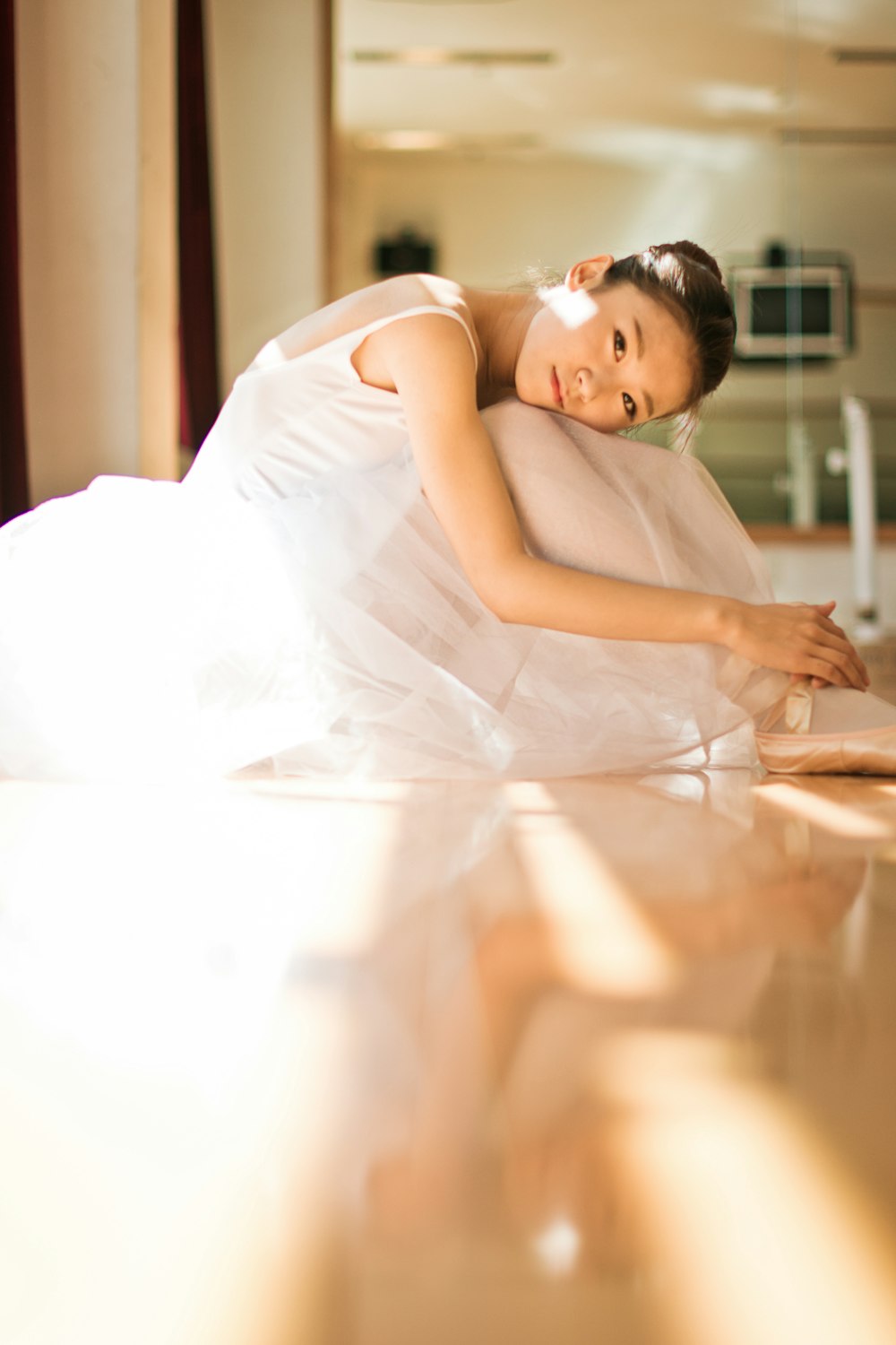 girl in white dress lying on floor