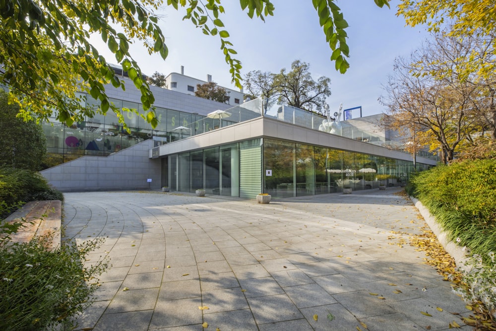 white concrete building near green trees during daytime