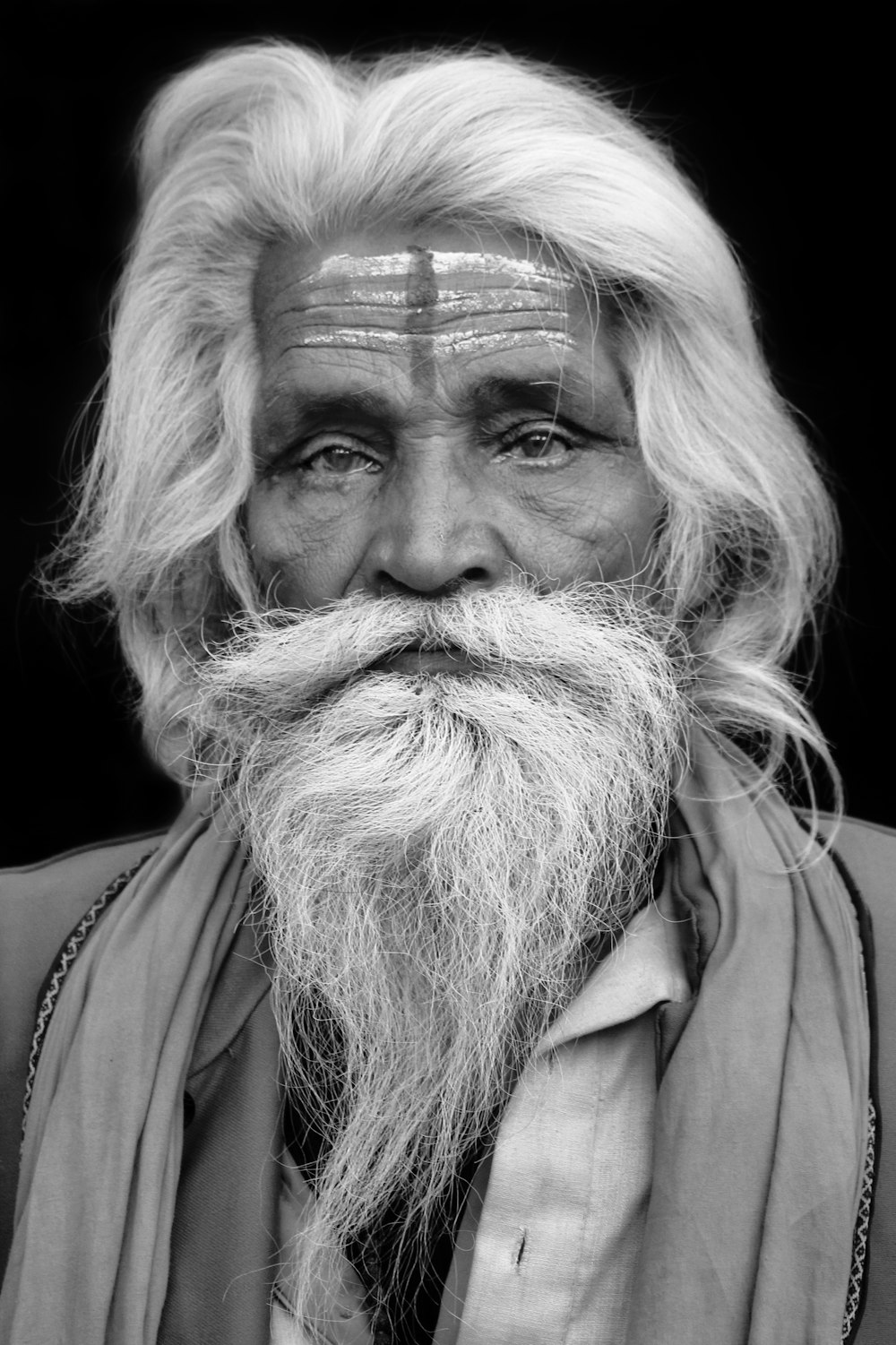 a black and white photo of a man with a long beard