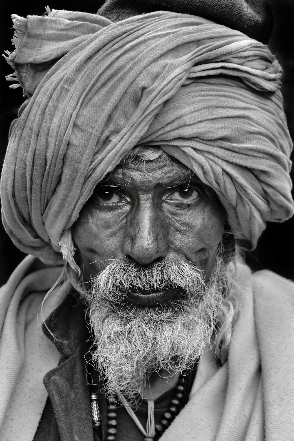 Una foto in bianco e nero di un uomo con un turbante