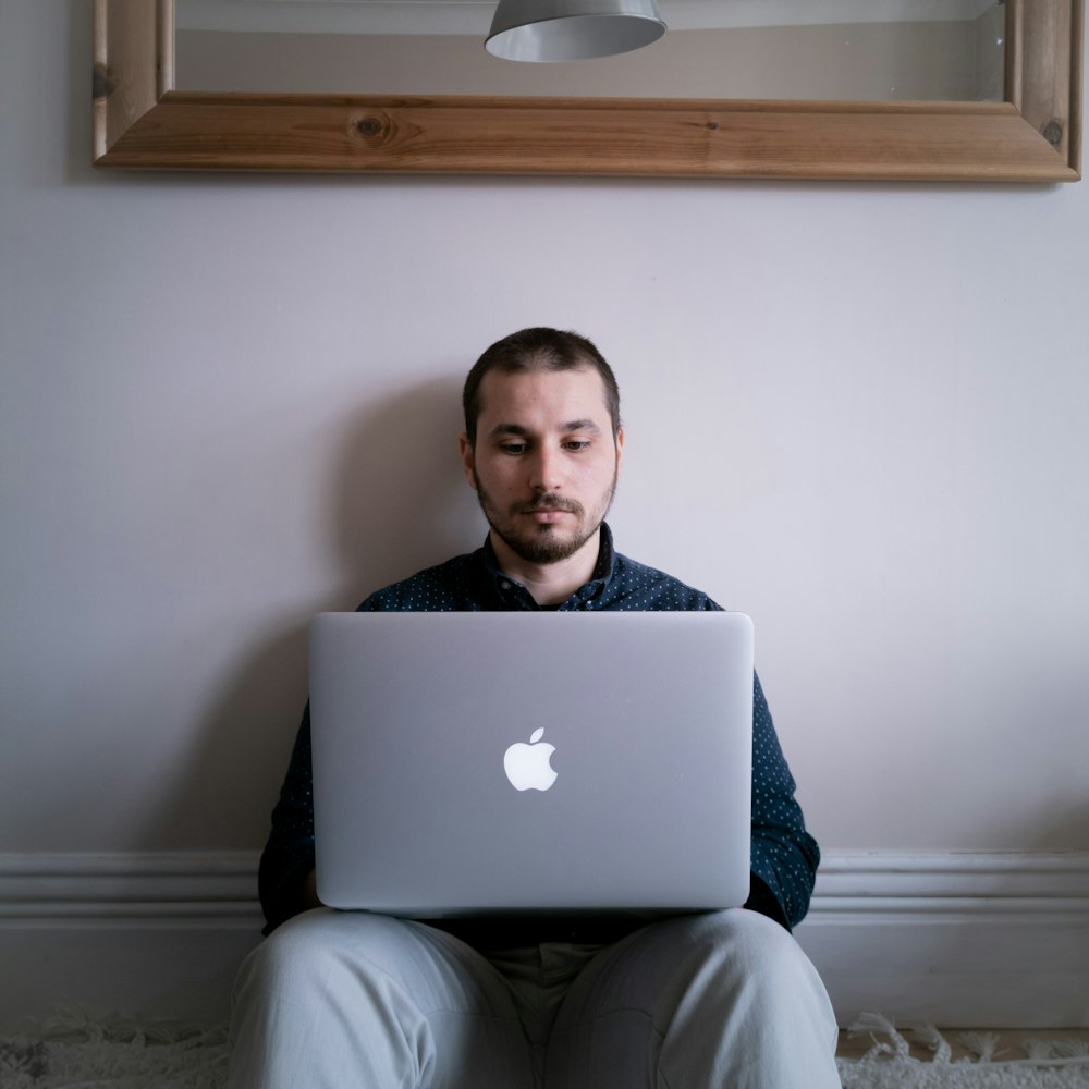 a man sitting in front of a laptop computer