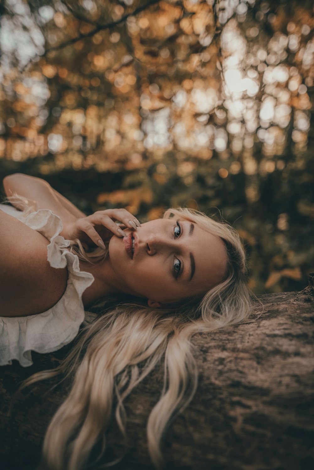 woman in white dress lying on ground