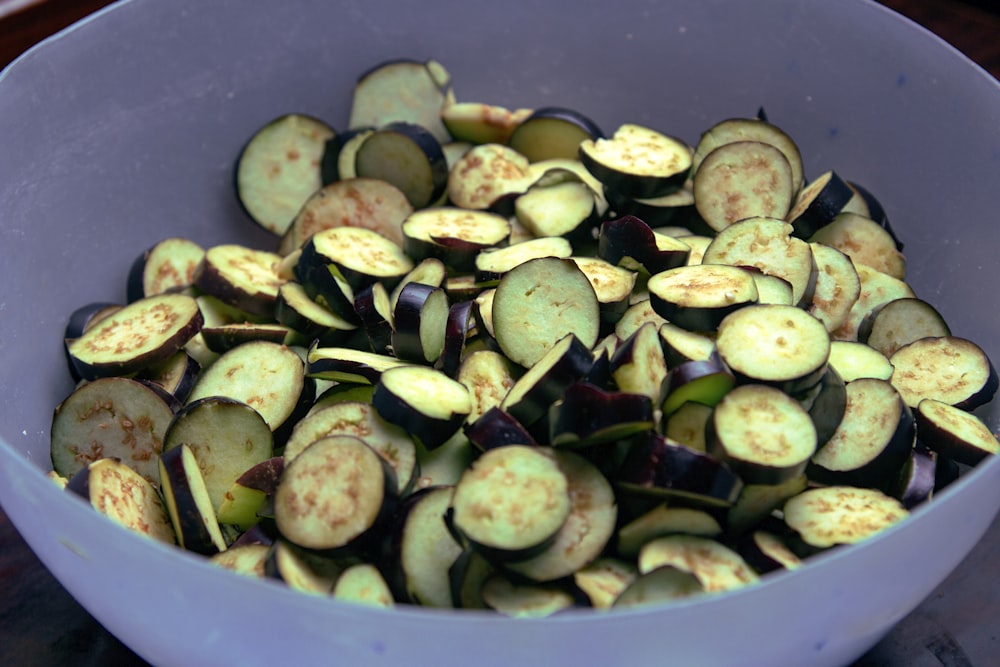 sliced cucumber in white ceramic bowl