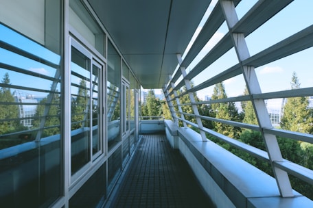 black metal railings near green trees during daytime
