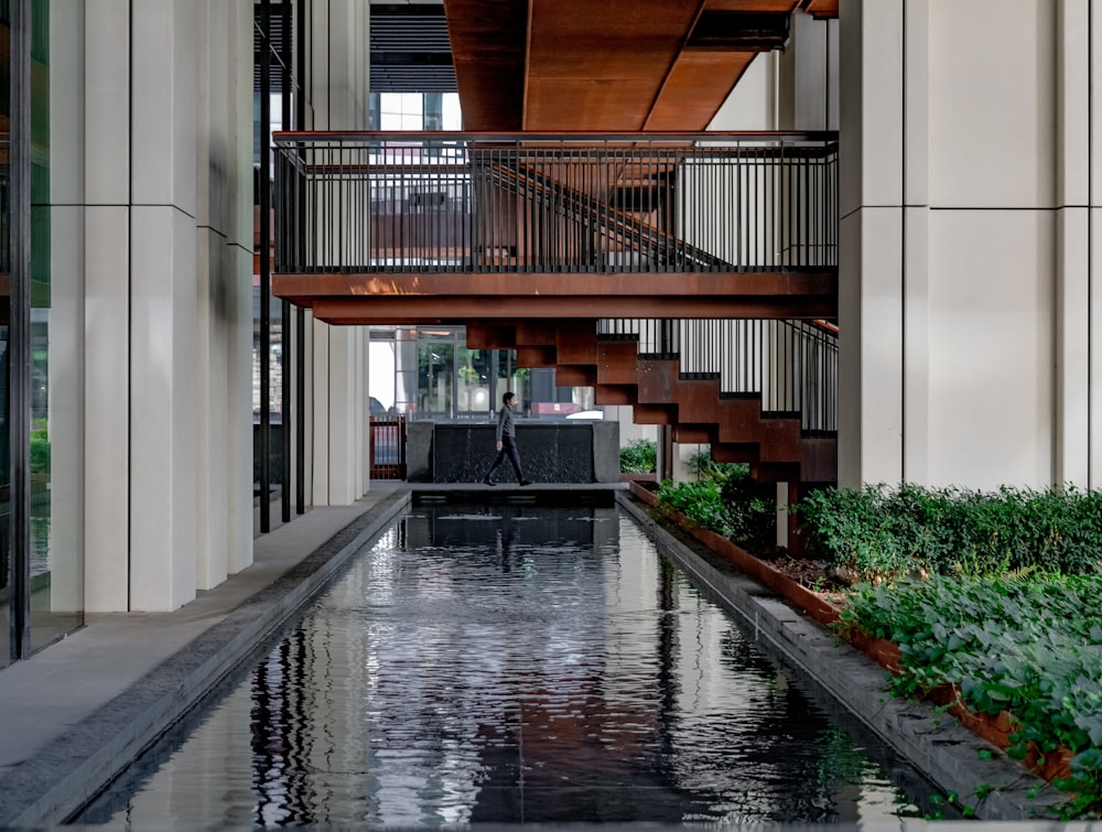 brown wooden staircase on white concrete building