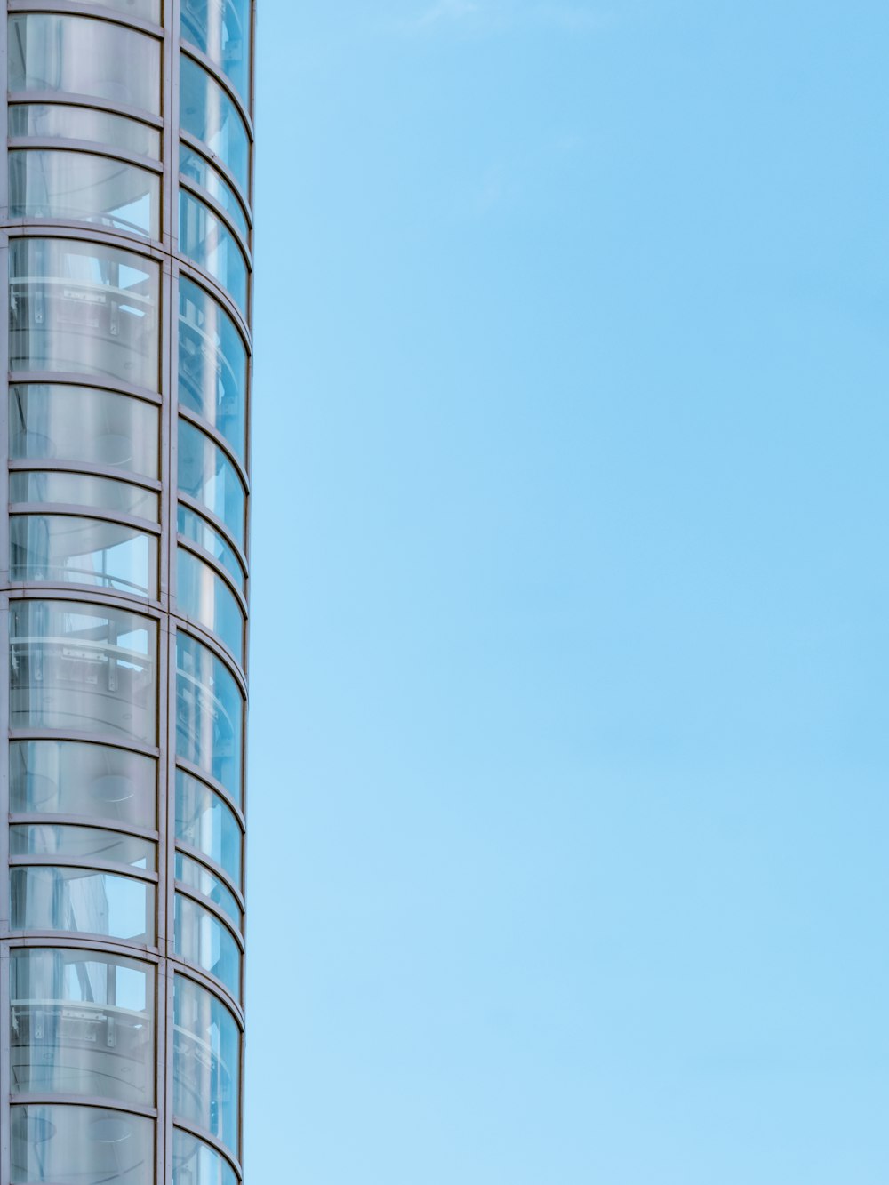 clear glass walled high rise building under blue sky during daytime