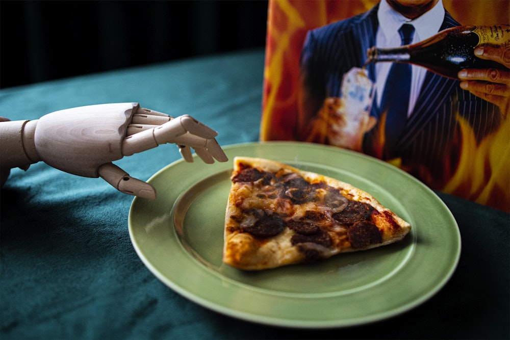 person holding sliced pizza on green plate